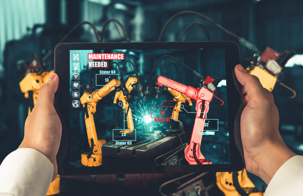 Engineer controls robotic arms by augmented reality industry technology application software. Smart robot machine in future factory working in concept of Industry 4.0 or 4th industrial revolution.