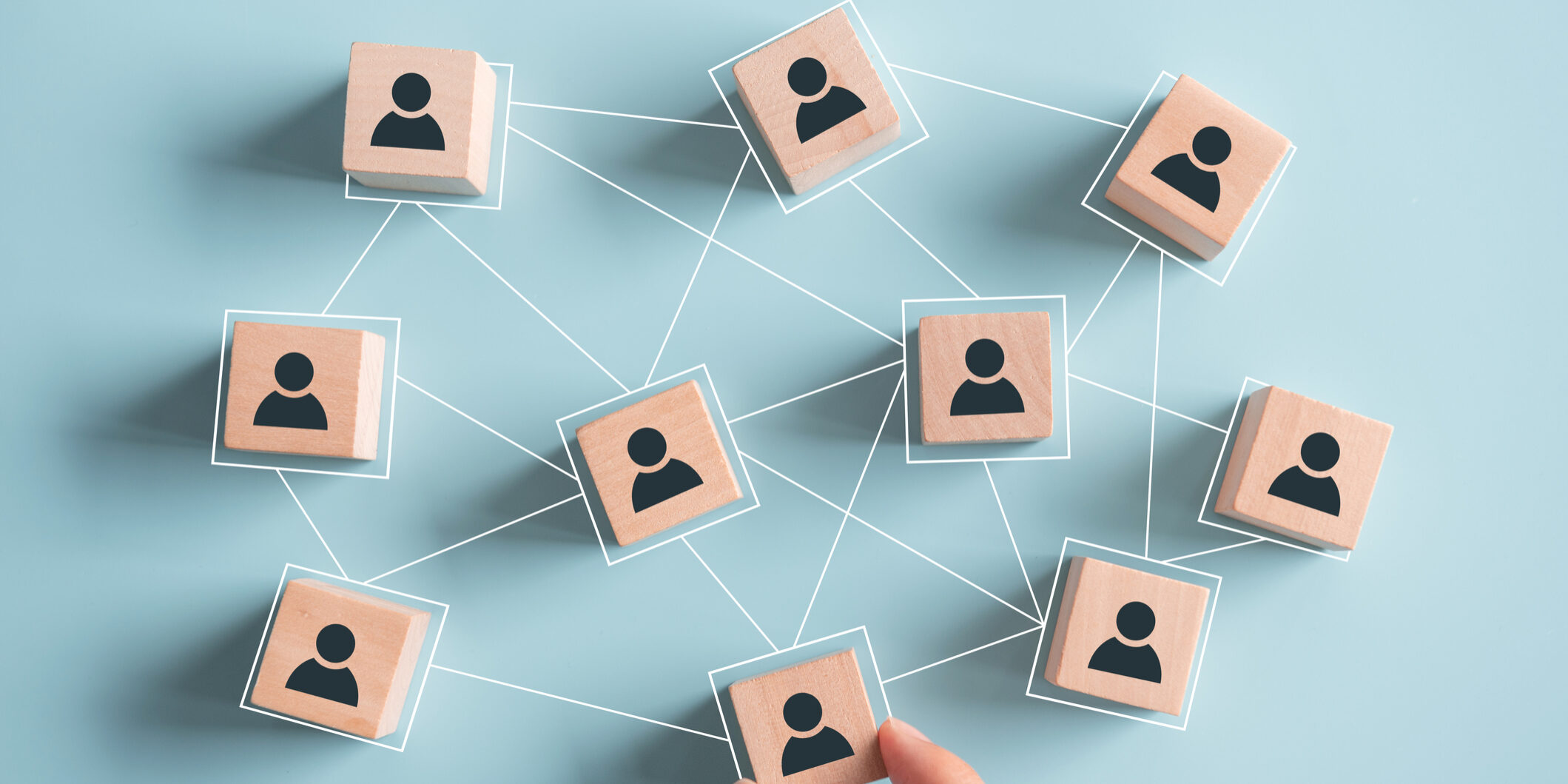 Building a strong team, Wooden blocks with people icon on pink background, Human resources and management concept.